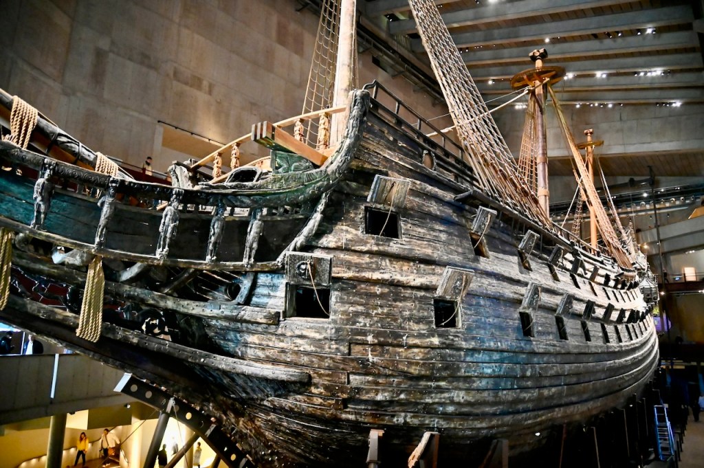 A close-up view of the Vasa ship displayed in a museum, highlighting its intricate woodwork and design.