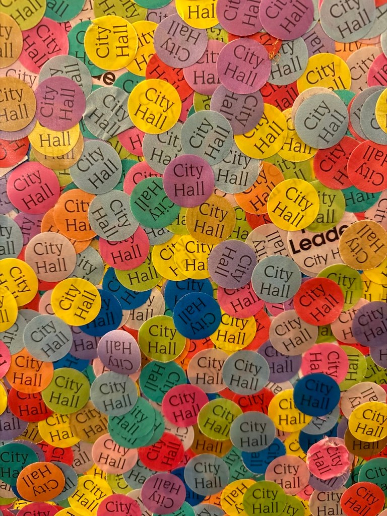 A colorful assortment of circular stickers featuring the text 'City Hall' in various colors and patterns.