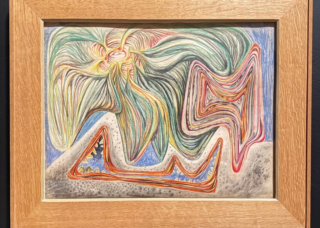 A colorful abstract drawing featuring swirling shapes and vibrant lines, framed in wood.