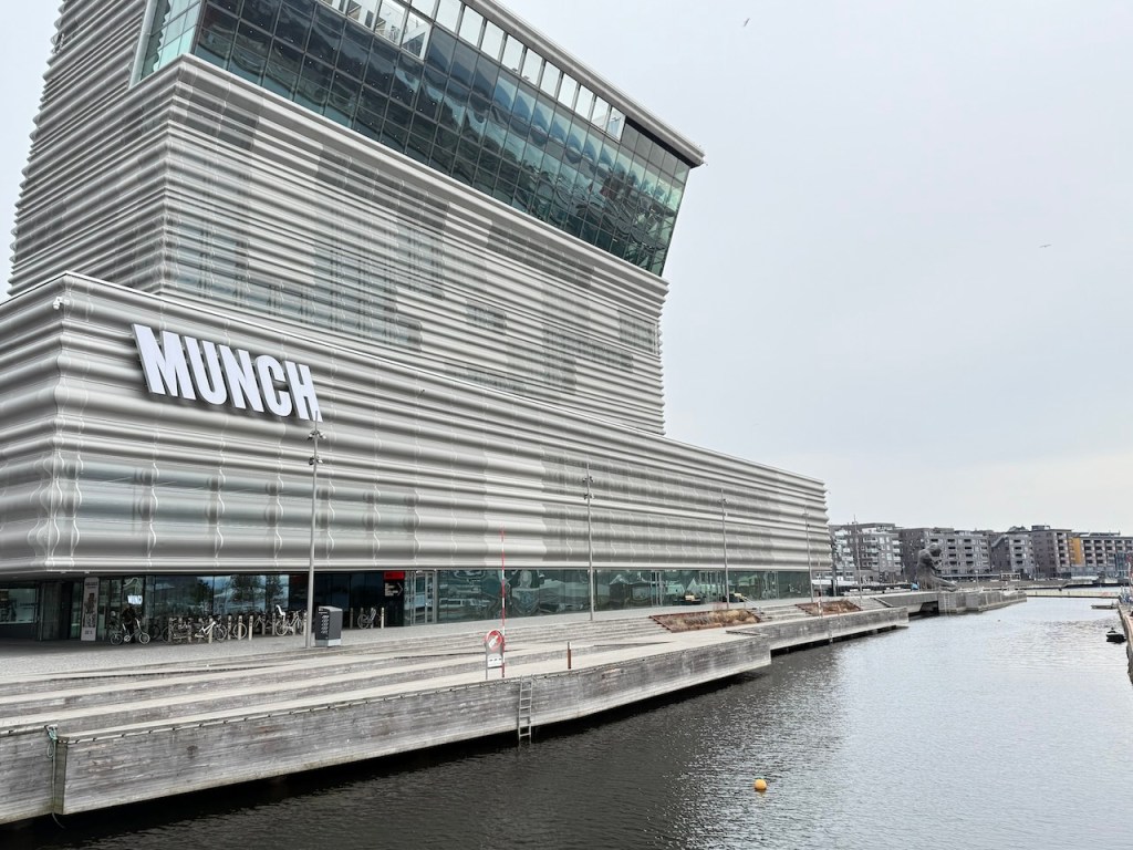 Exterior view of the Munch Museum in Oslo, showcasing its modern architectural design along the waterfront.